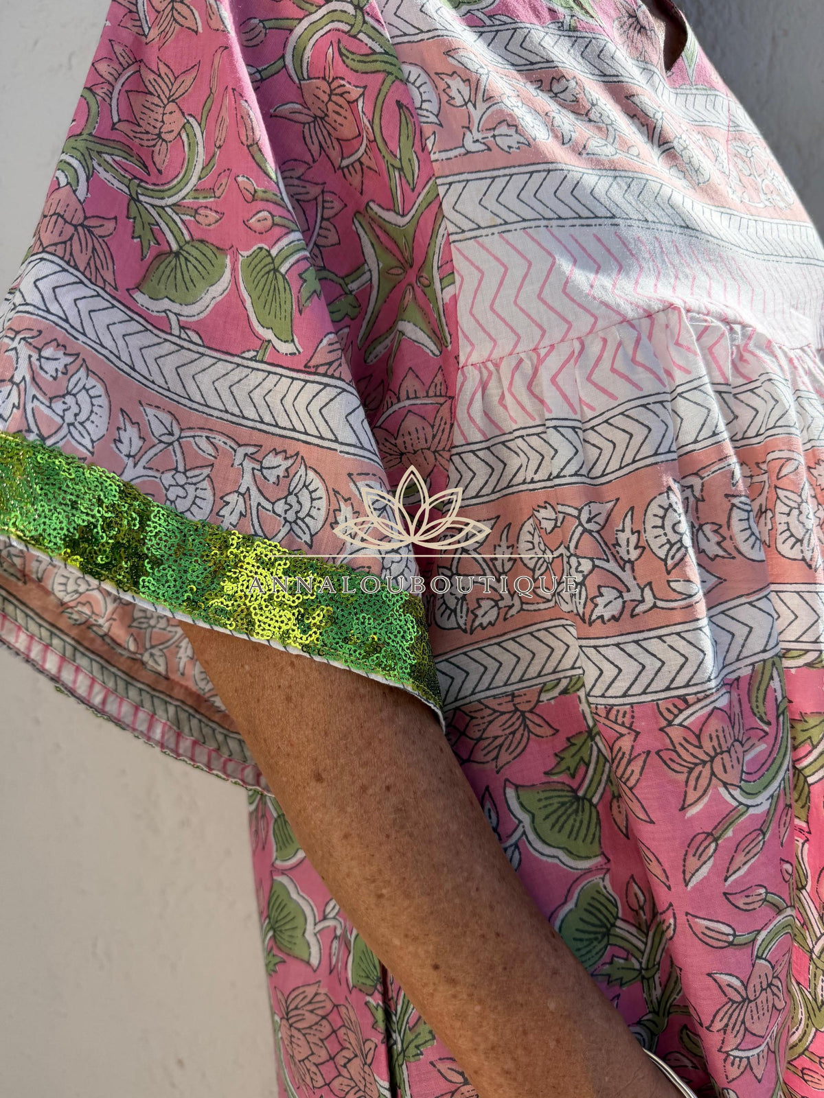 Loose pink and green dress with sequin sleeves