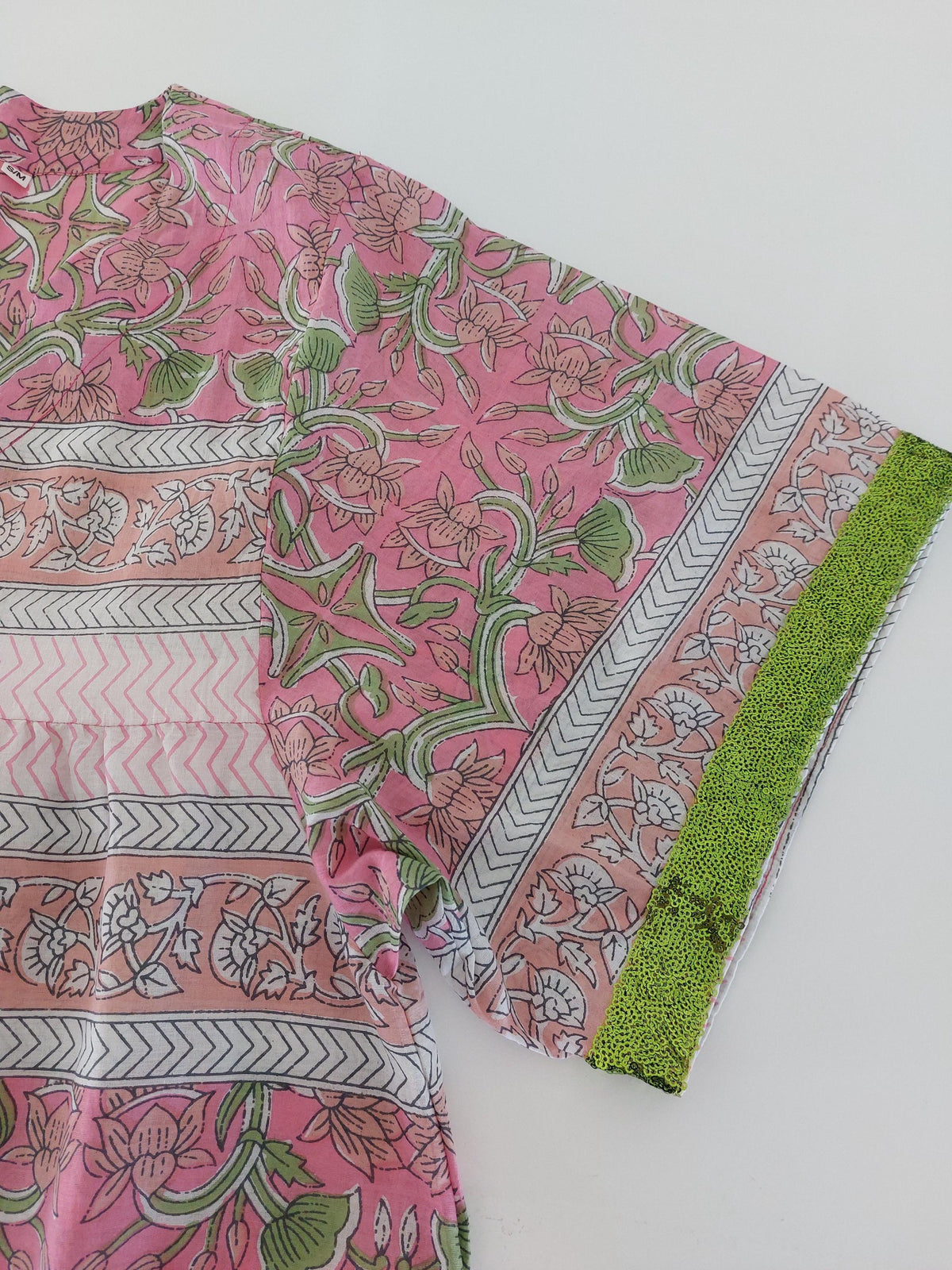 Loose pink and green dress with sequin sleeves
